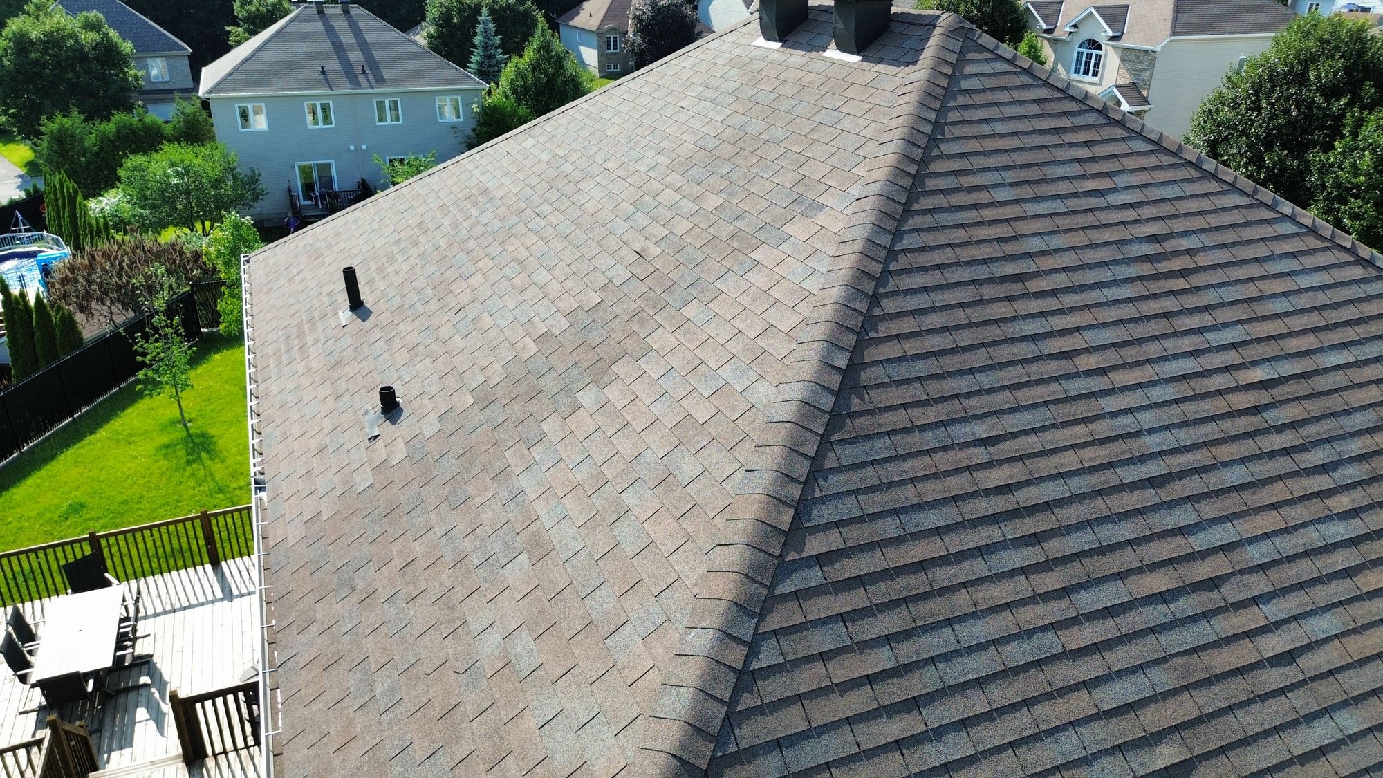 Aerial view of previous shingle repair, missing shingle, and shingle lifting found by a home inspector in Nepean